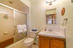 This bathroom is shared by the queen and twin bedrooms. It has a combination tub and shower.